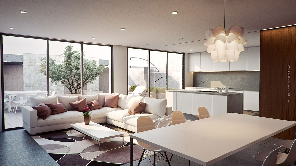 Eingerichtetes Wohnzimmer mit Einbauküche und großen Fenstern zur Terrasse, Couch, Tisch und Designerlampe